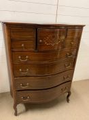 A Serpentine Fronted chest comprising four small drawers and a cupboard over four long drawers