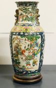 A large vase of slightly ribbed baluster form and folded rim with 'Famille verte' enamelled