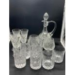 A selection of cut glass decanters including tumblers and wine glasses