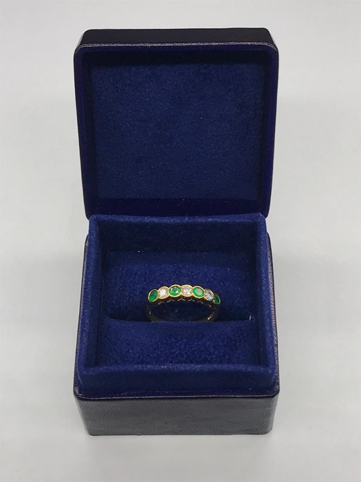 An Emerald and Diamond Half Eternity Ring