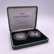 A 1997 2 x 50 p Silver Proof coin set old 50p and New 50p.