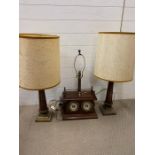 A desk top lamp with temperate gauges and a pair of table lamps on brass bases