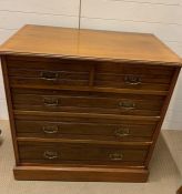 A two over three chest of drawers with brass handles (H90cm W91cm D51cm)