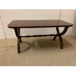 A mahogany coffee table with cross legs (H44cm W92cm D40cm)