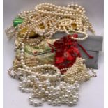 A Large volume of pearl necklaces in various styles and fashions with various makers.