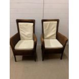 A pair of Lloyds Loom armchairs with white cushions