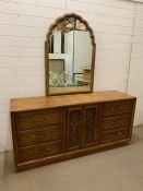 A sideboard with mirror with double door to centre with three drawers either side (H205cm W178cm