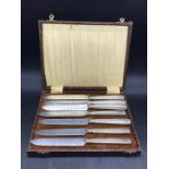 A Cased set of silver, hallmarked, handled knives (one extra)