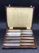 A Cased set of silver, hallmarked, handled knives (one extra)