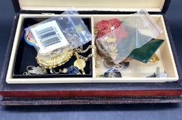 A wooden jewellery box with a selection of costume jewellery inside