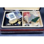 A wooden jewellery box with a selection of costume jewellery inside