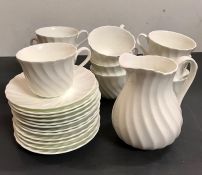 A selection of eight Wedgewood cups and saucers with a milk jug