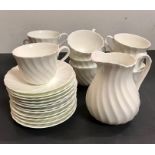 A selection of eight Wedgewood cups and saucers with a milk jug