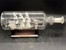 A Lichfield glass sculpture of a ship in a bottle "Hms Bounty"