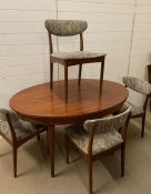 A Mid Century dining table and four chairs, possibly G-Plan fresco teak