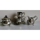 A Swedish silver 830 matching lidded sugar bowl and cream jug, each on four feet, 354g and a pair of