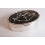 A George V silver and tortoiseshell oval trinket box with festoon inlay decoration, lined interior