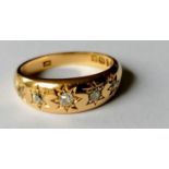 An Edwardian five-stone graduated diamond and gold gypsy ring of tapering form, size M, hallmarked