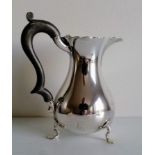 A George V silver water jug of baluster form on trefid feet by Stokes & Ireland Ltd., Chester, 1918,