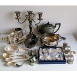 An assortment of silver plated ware to include a meat cover, candelabra, teapot, napkin rings,