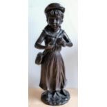 A bronzed metal figure of a girl with hat, 59 cm H