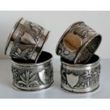 Three white metal Indian-style napkin rings and one Chinese-style (slight split), all with vacant