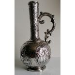 A 19th century Russian silver long necked vase with later side handle and base, heavily embossed