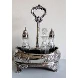 A Victorian silver cruet stand with repousse decoration, two conforming silver-topped bottles and