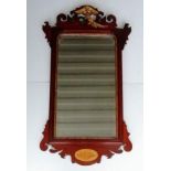 A Georgian walnut-framed wall mirror with carved parcel gilt ho-ho bird, conch shell detail and