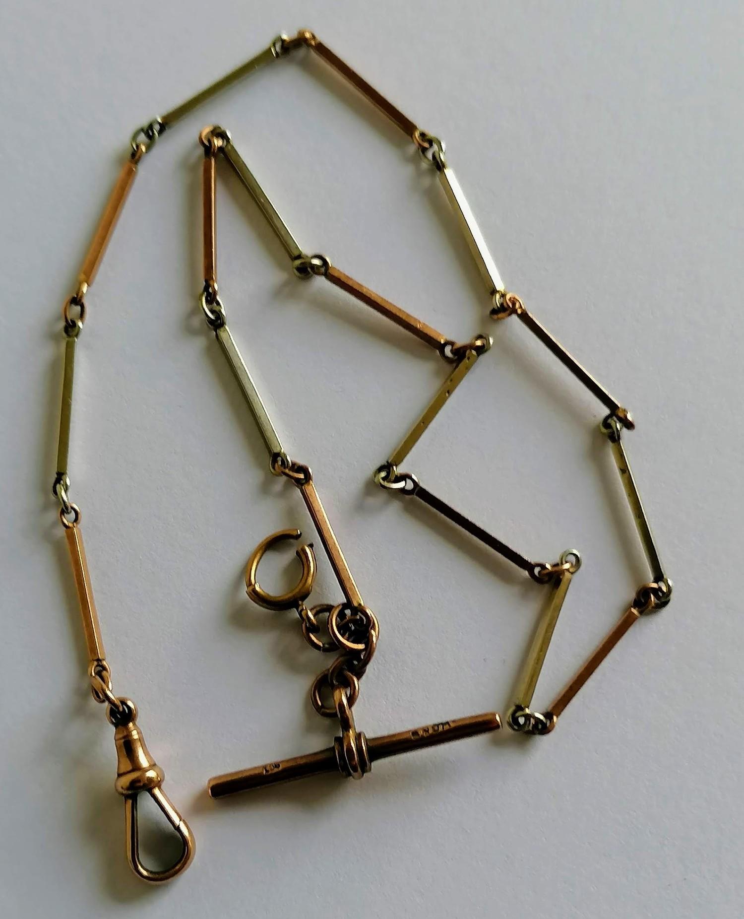 A 9ct yellow and white gold Albert chain, stamped to t-bar and clasp, possible by William