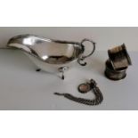 An Irish silver boat-shape sauce boat with Celtic knot design to rim, acanthus wrapped scroll handle