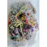 An assortment of mixed costume jewellery, etc