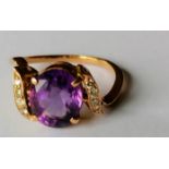 An amethyst (10 x 8mm) and diamond crossover gold ring, size O, not hallmarked, 3.55g