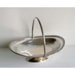 A Victorian silver oval swing handle basket with Islamic-style decoration on a single foot,
