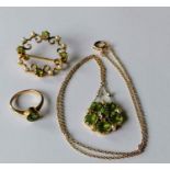 An Edwardian peridot and seed pearl pendant on a 9ct gold and integrated chain, stamped 15ct; a