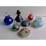 Four Isle of Wight glass perfume bottles, two paperweights and a small vase, all without visible