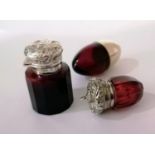 A Victorian silver-topped ruby glass scent bottle with embossed flip-top cap, original stopper by