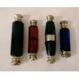 A set of four late 19th century silver-mounted double-ended glass scent bottles with faceted