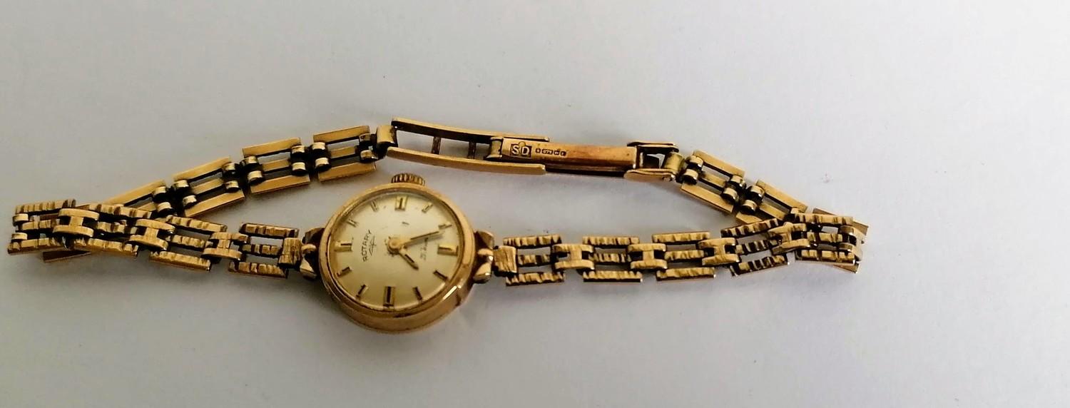 A mid-20th century ladies Rotary wristwatch with a 9ct gold case and strap, hallmarked, two spare