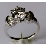 A diamond ring, the central round brilliant-cut diamond measuring an estimated 8.7 x 8.6 x 5.2mm,