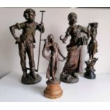 A pair of Edwardian bronzed spelter bucolic figures, 44 cm, and two other on socles (3)