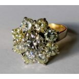 A diamond cluster ring mounted on 18ct yellow gold; nine round brilliant-cut diamonds, central