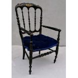 A Victorian lacquered child's chair with painted gilt floral decoration and fabric upholstered seat,