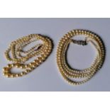 A graduated string of pearls with a 9ct yellow gold clasp, 78 cm and a choker double rope of