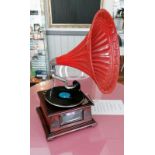 A wind up horn gramophone, 'The Crown' with red painted tinplate horn on a mahogany base