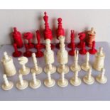 A late 19th century natural and red stained ivory chess set, King height 10cm, complete and