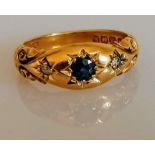 An Edwardian 18ct yellow gold gypsy ring set with sapphire and diamonds, carved decoration, size