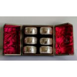 A cased set of six Victorian silver napkin rings with etched decoration, vacant cartouches, by Hayes
