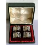 A George V cased set of four silver napkin rings with pierced decoration, numbered, hallmarked and