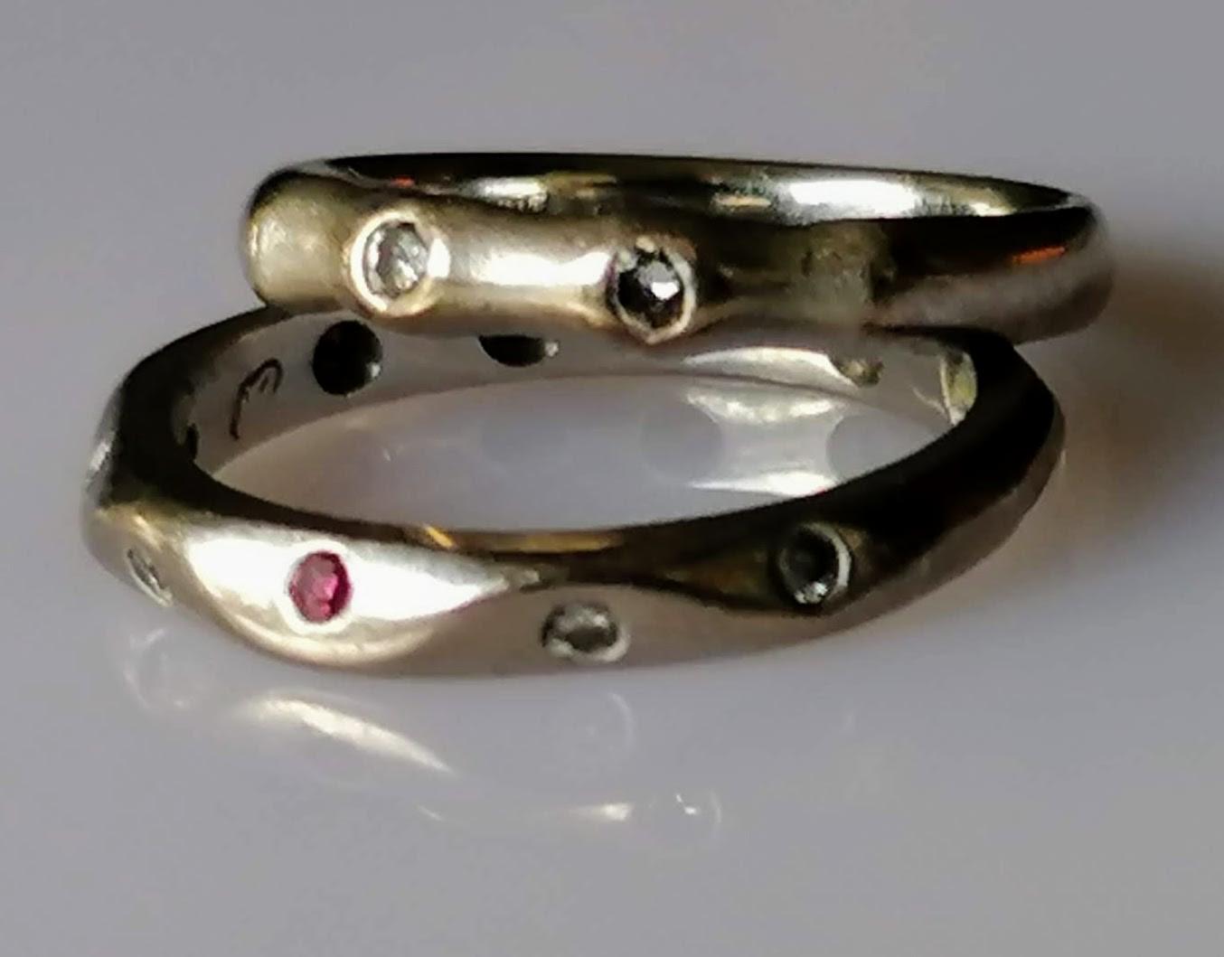 A Jeremy Hoyle carved 18ct white gold ruby and diamond eternity ring, size K and another similar